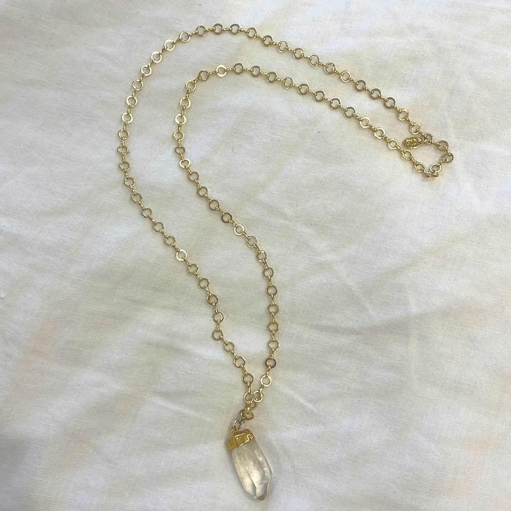 Long gold tone necklace with crystal pendant